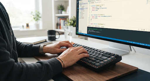 Close up of a programmer typing TypeScript code on a mechanical keyboard