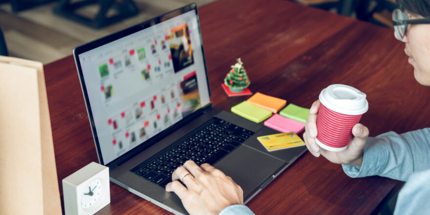 Man holding laptop and typing keyboard looking product for shopping online.